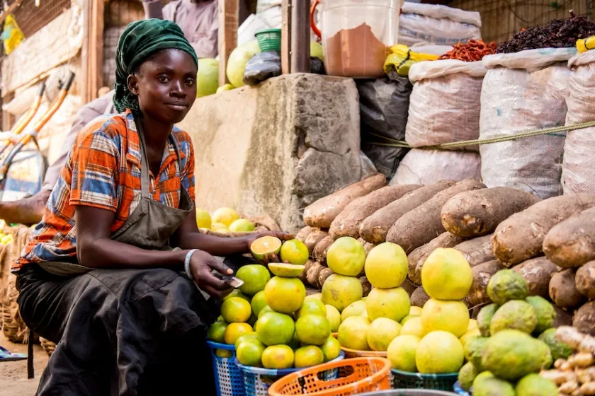 A young woman with a fruit stall