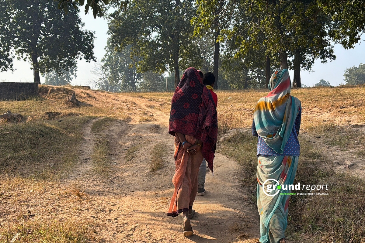 "Tribal villagers from Basi Berdah village gather in protest against Adani Group's coal mining project in Dhirauli, Singrauli, with women activists participating alongside men"