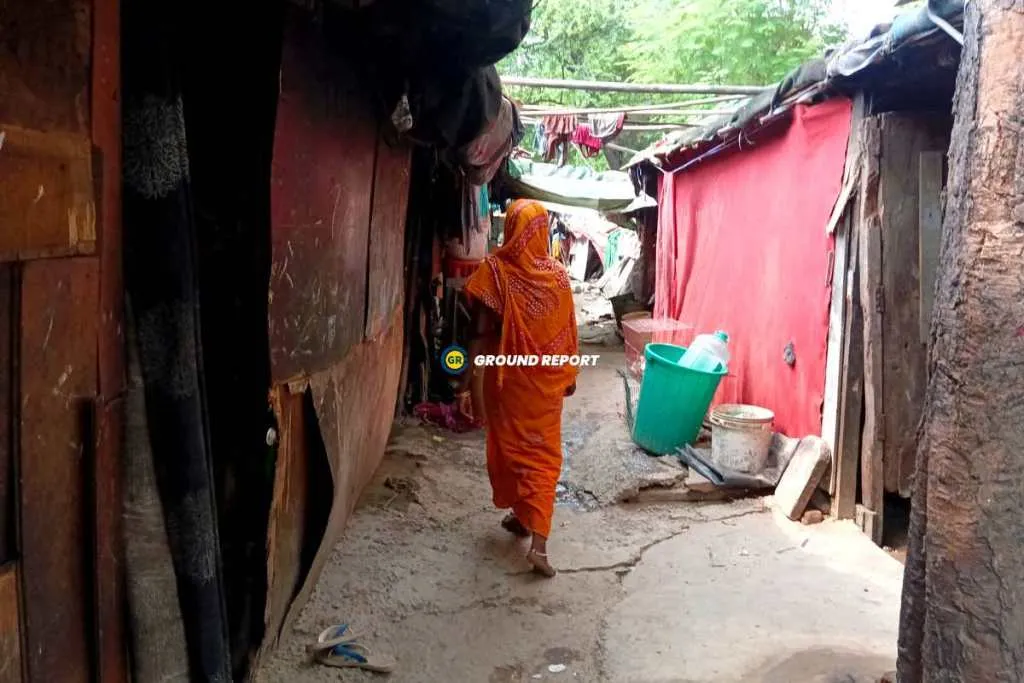 Woman showing makeshift houses affected by floods